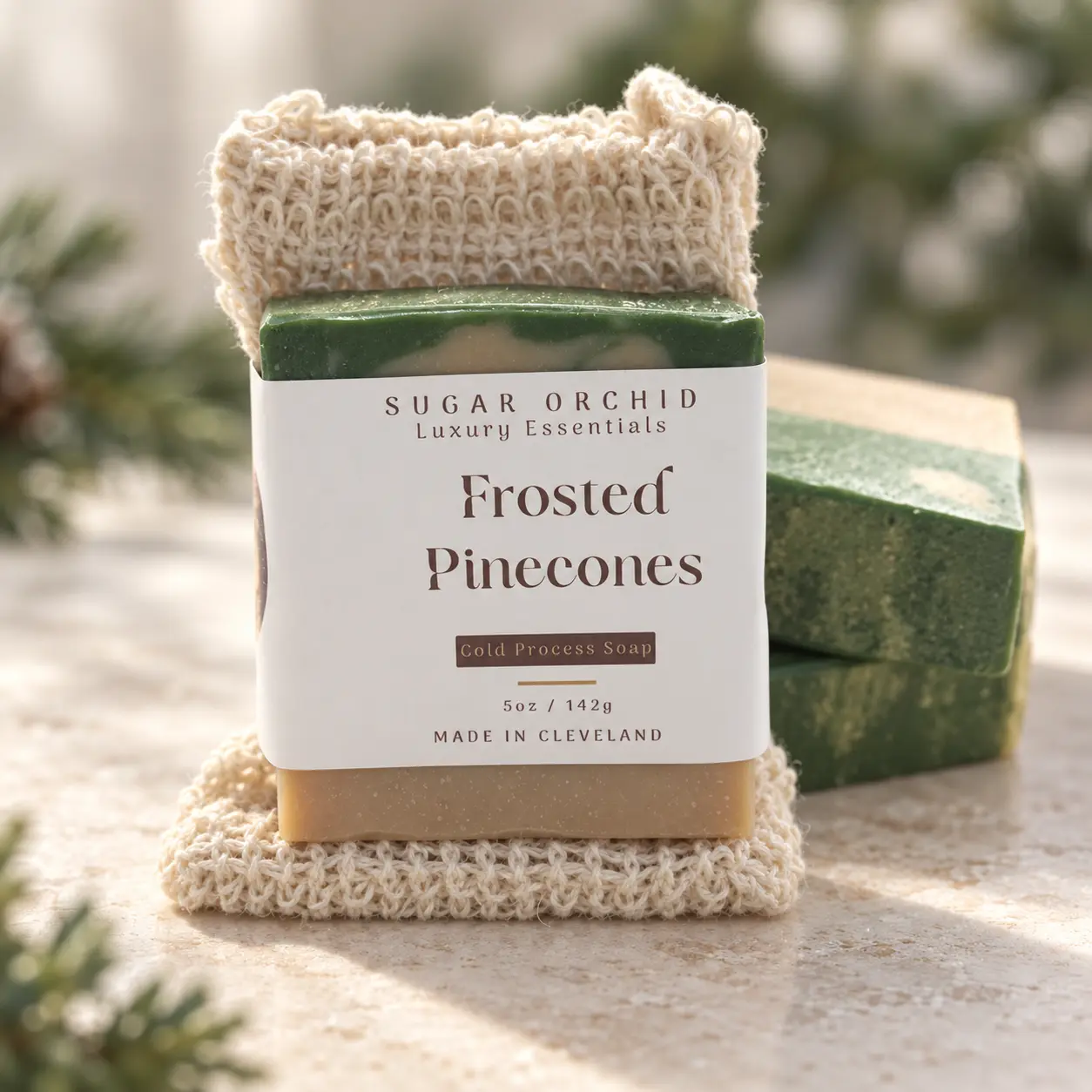 Labeled Frosted Pinecones soap with a natural soap saver